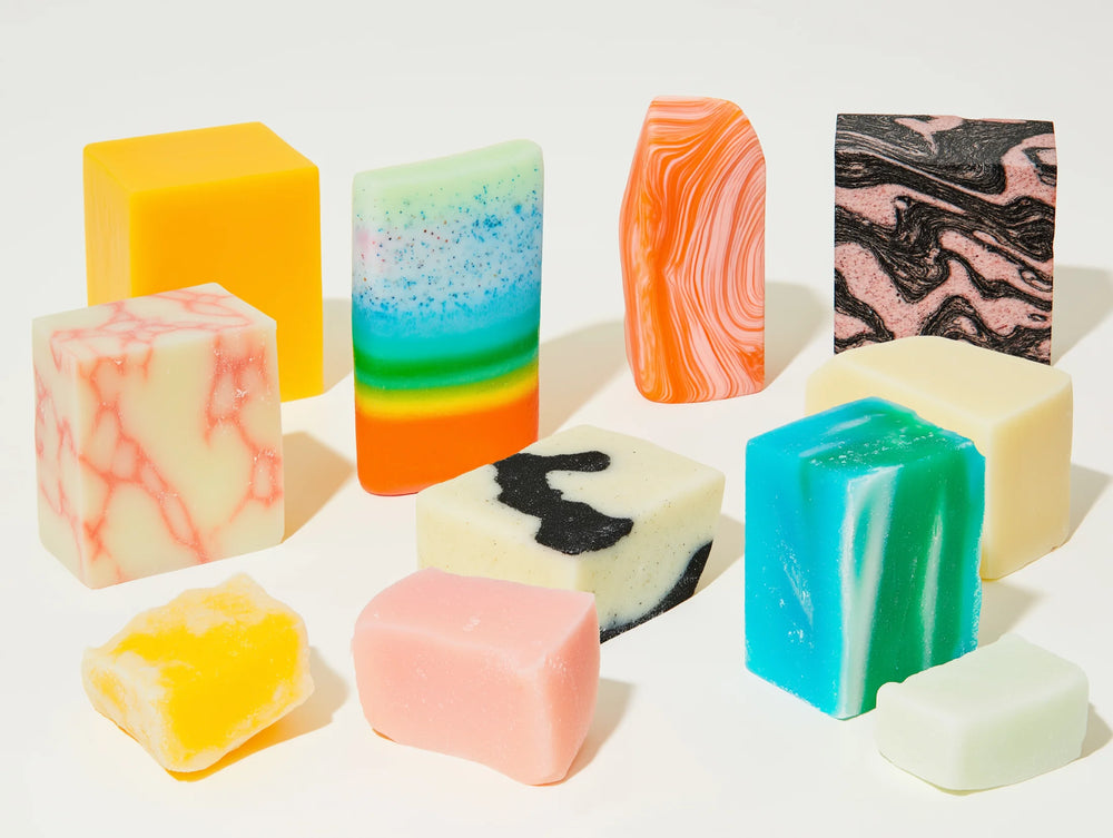 Assorted colorful soap bars on a white background