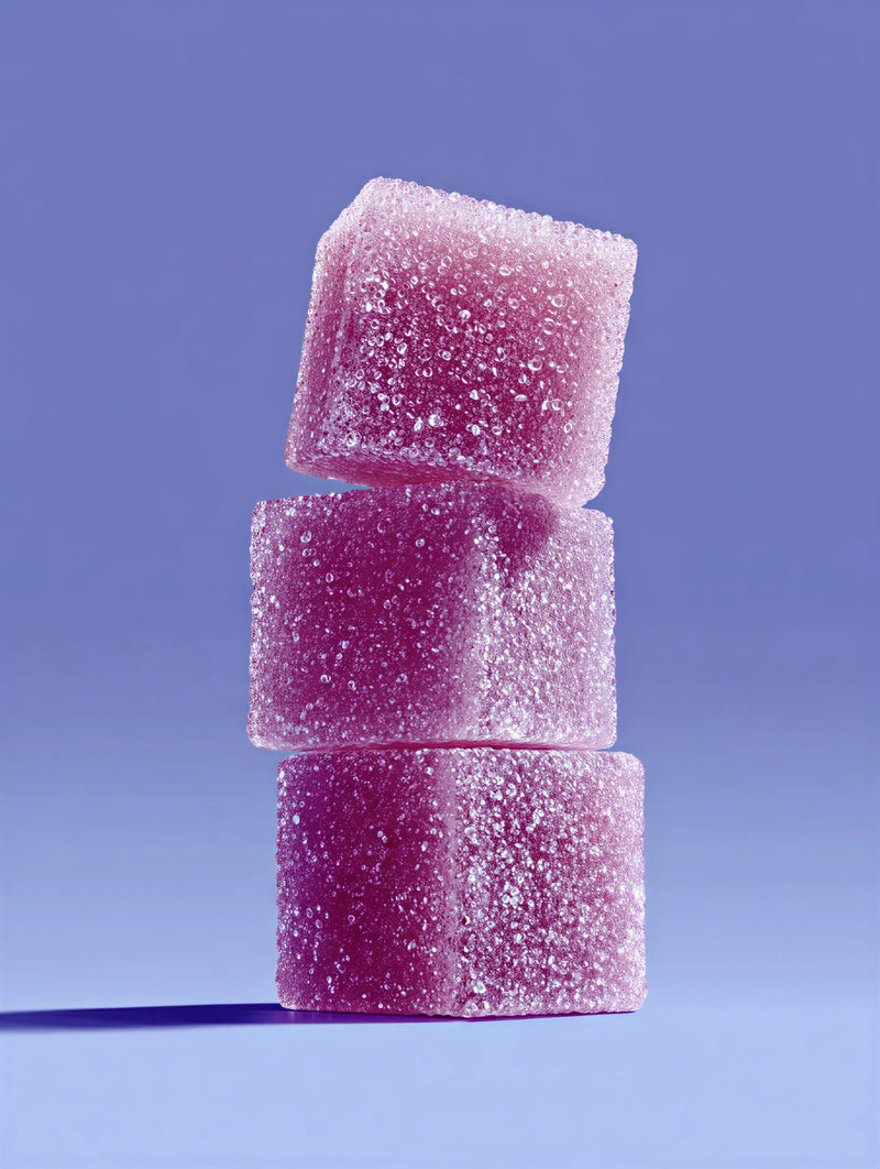 Stack of pink gumdrops against a purple background
