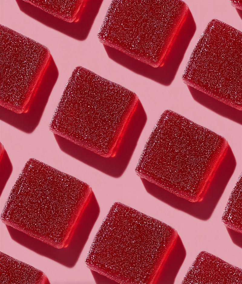 Red glittery cubes on a pink background