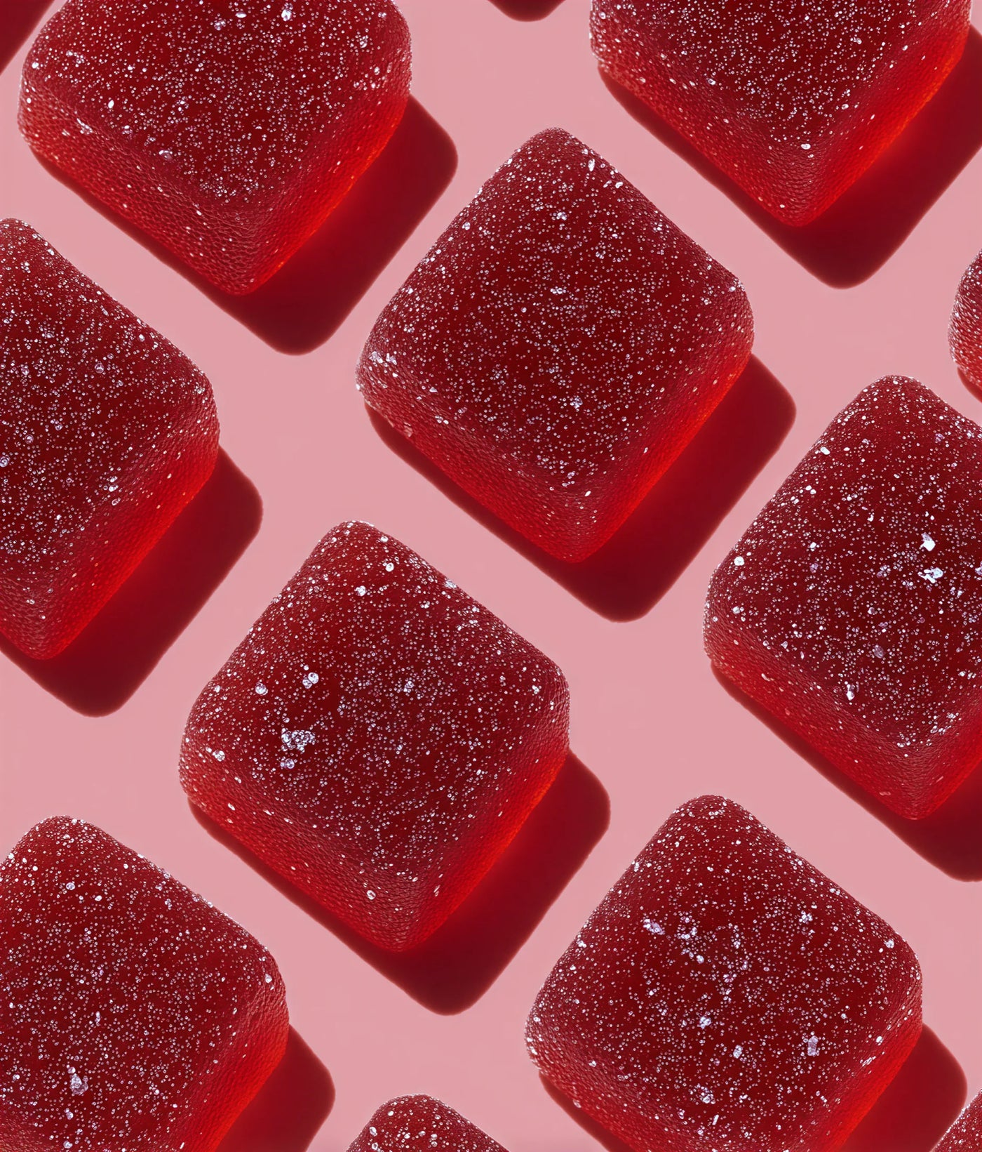 Red gummy bears on a pink background