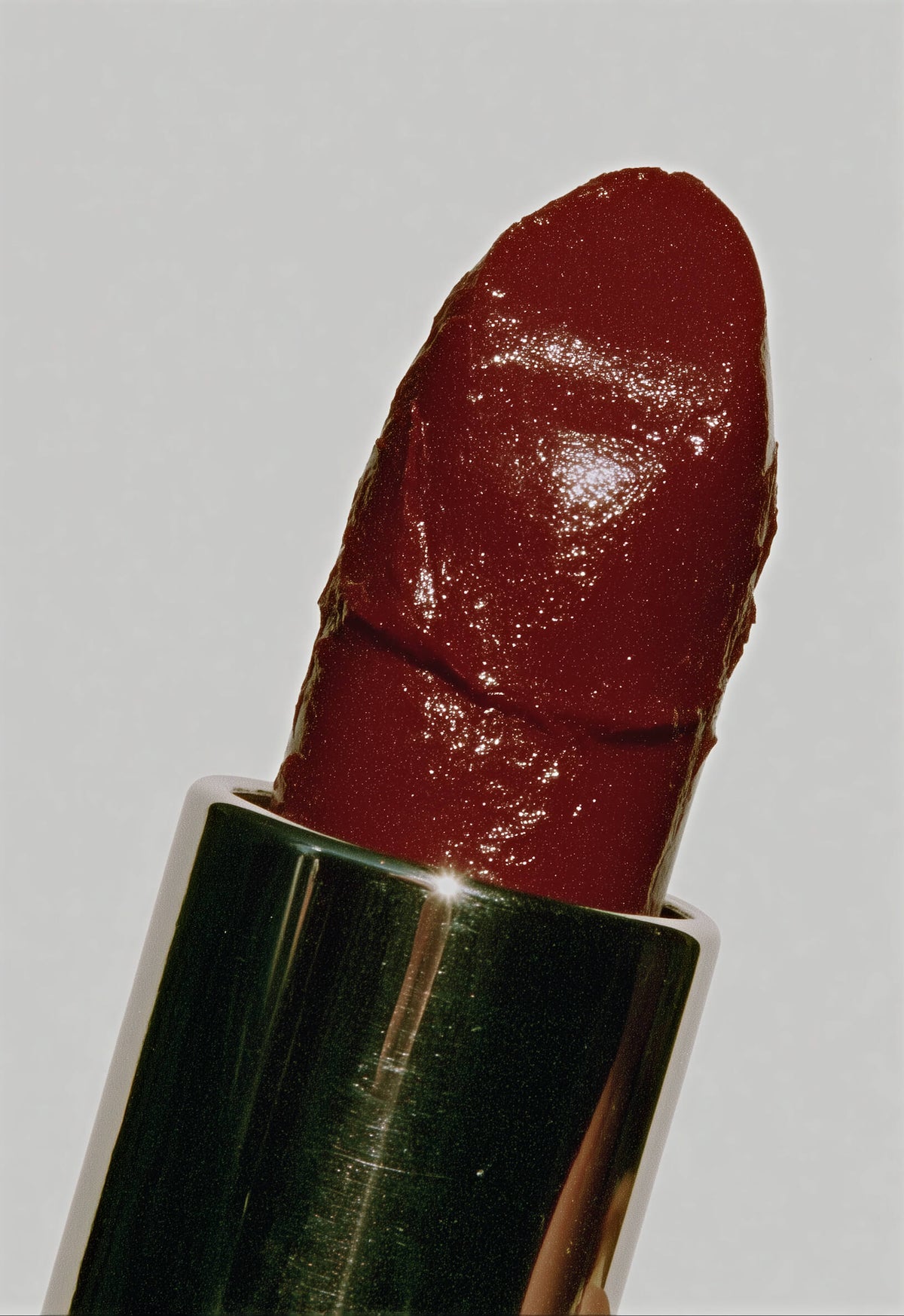 Close-up of a red lipstick on a light gray background