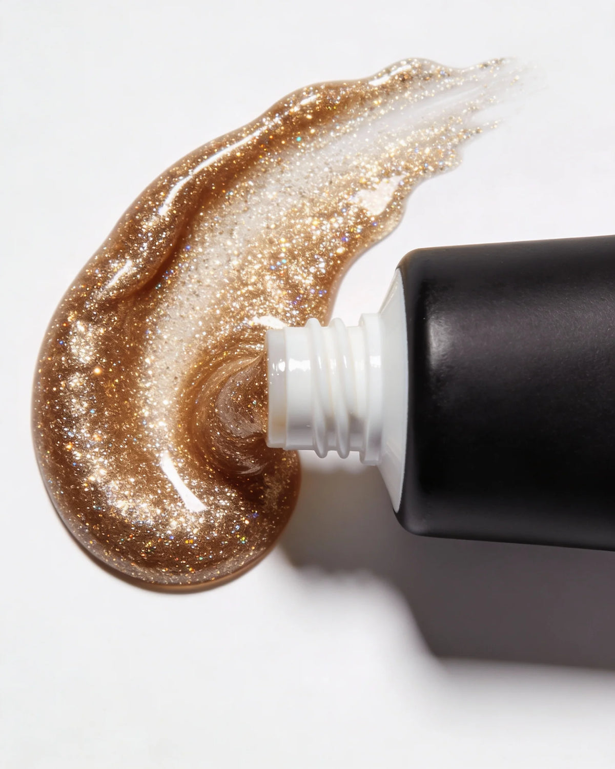 Close-up of a tube of glittery cream on a white background