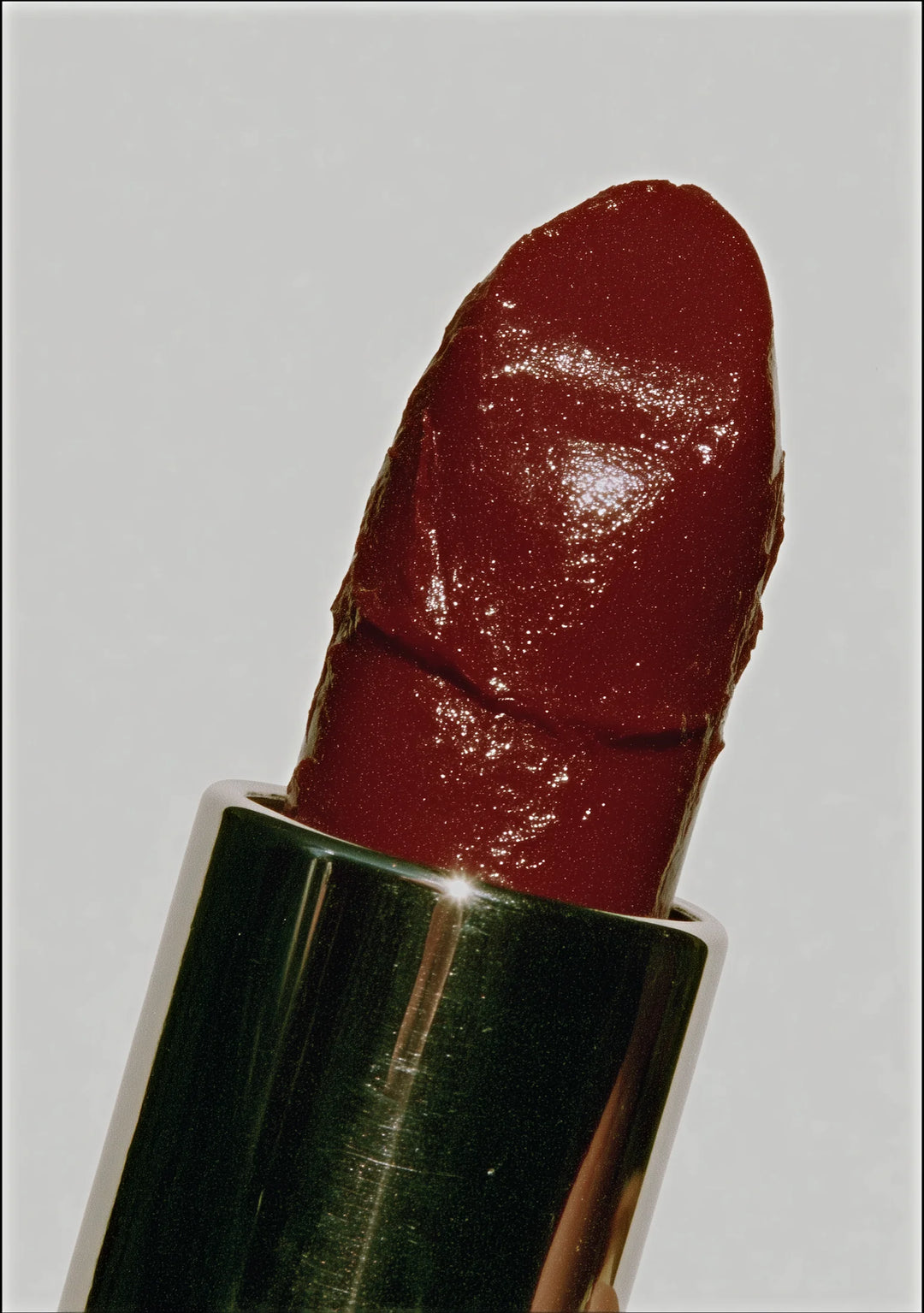 Close-up of a red lipstick on a light gray background