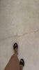 Feet with black sandals walking